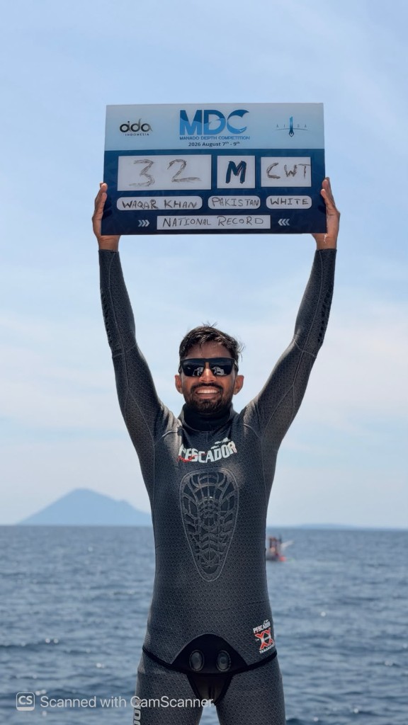 Waqar Khan holding a 32 metre constant weight national record board at the Manado Depth Competition